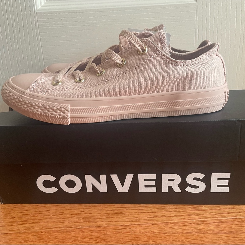 Brand new, Chuck Taylor’s with gold grommets.